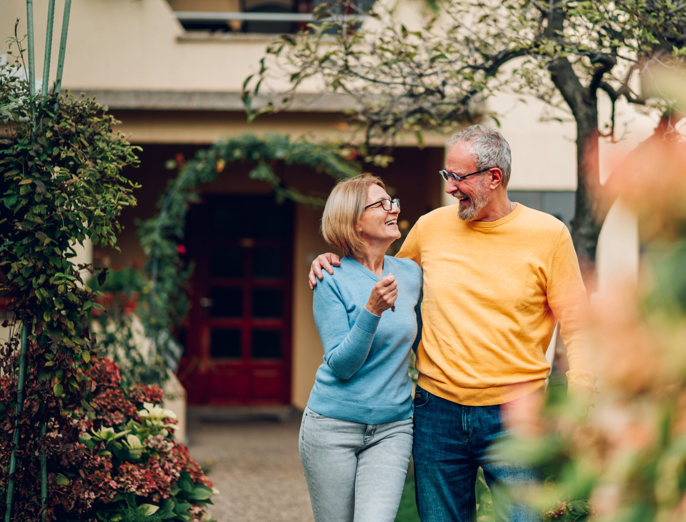 Elderly couple looking at each other walking in local Highstreet
